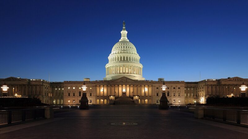 United States Capitol building illuminated at dusk against a deep blue sky