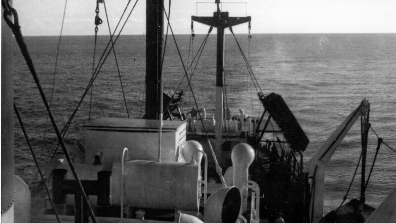 Merchant ship seen from the stern at sea