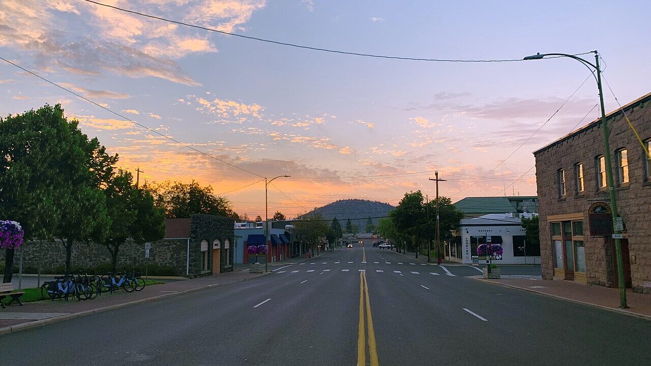 Downtown Bend Oregon street with Pilot Butte at sunset
