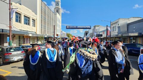 University graduates in academic dress at a graduation procession